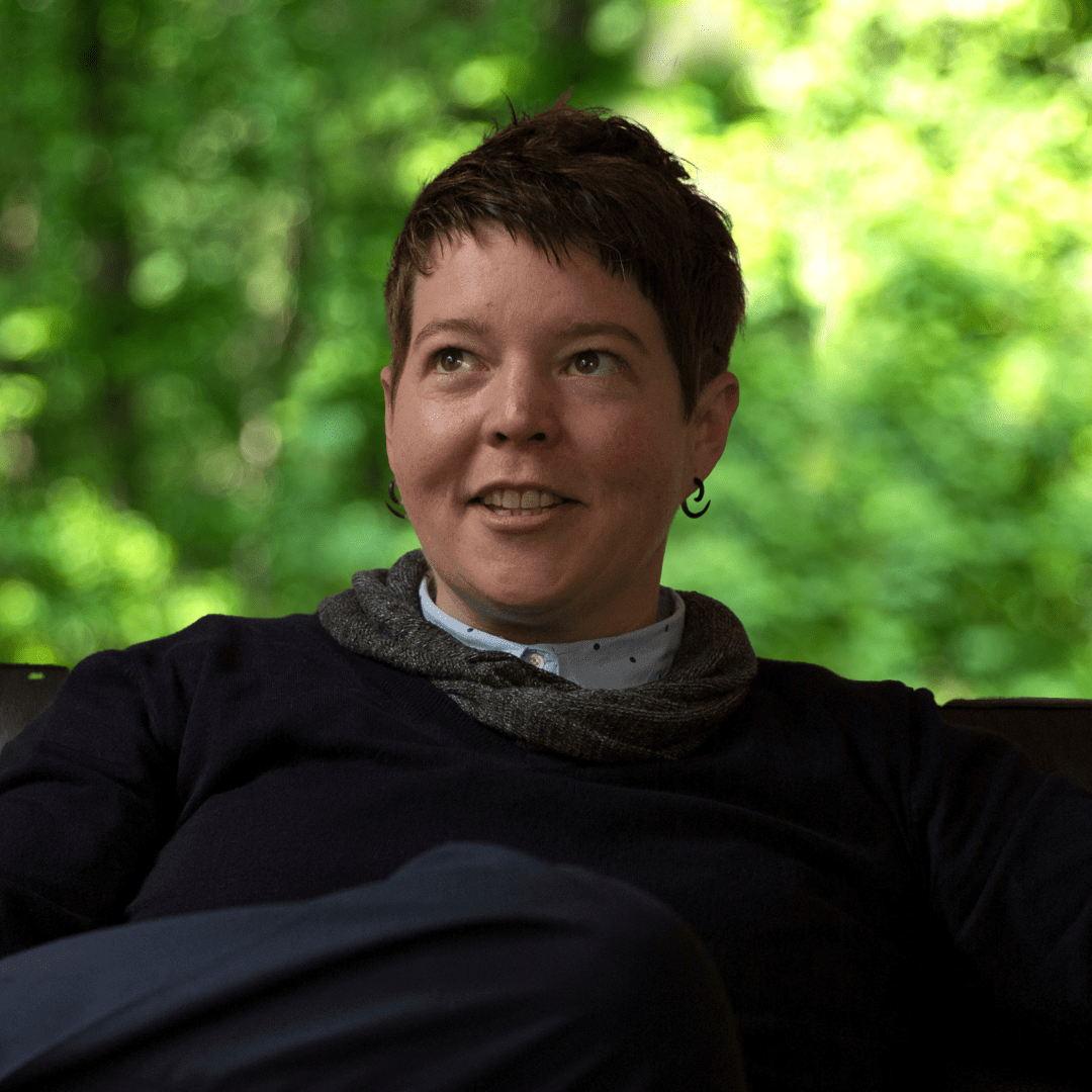 headshot of abby neyenhouse. woman looking up with dark clothing
