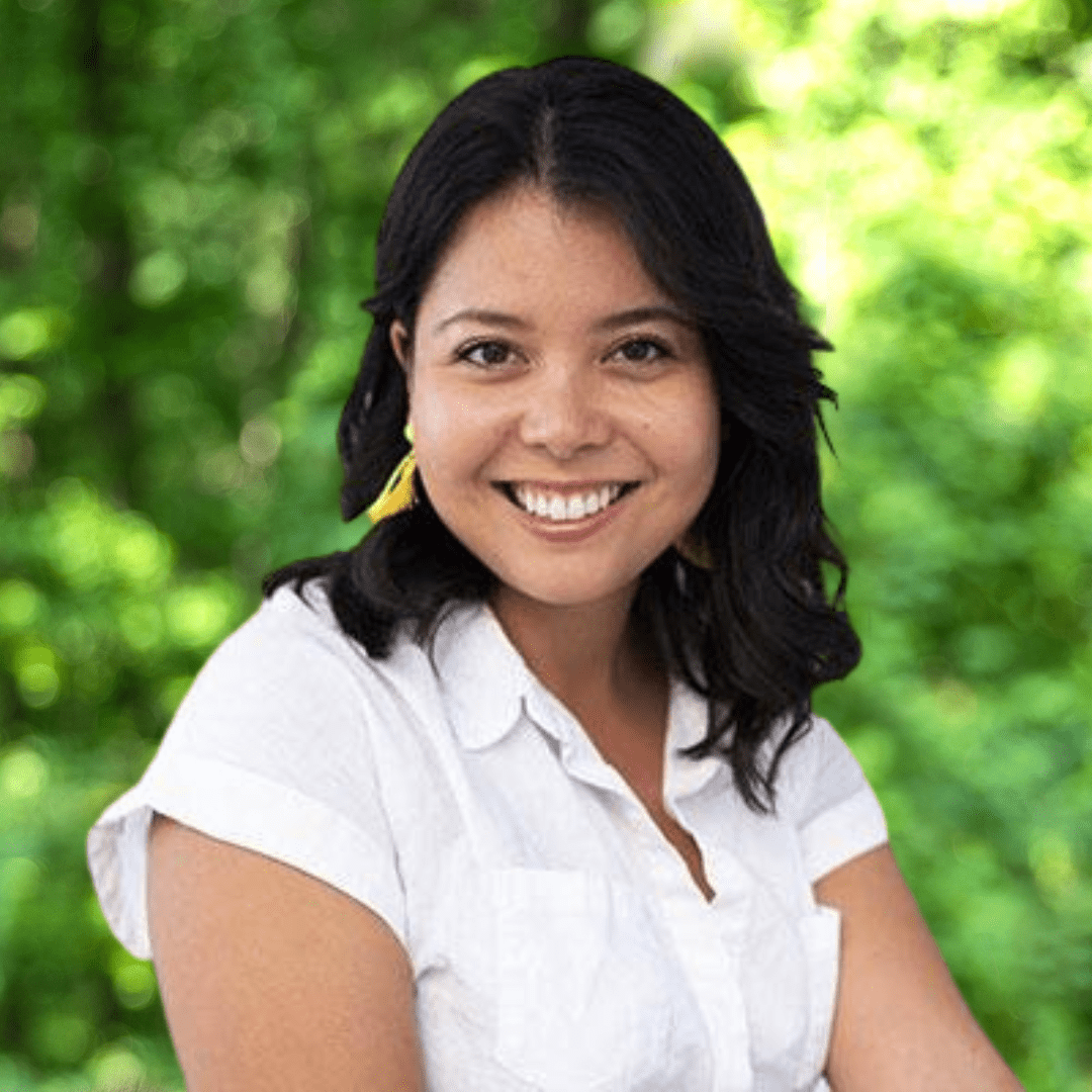 Headshot of Cathy Teixeira. Woman smiling with white blouse.