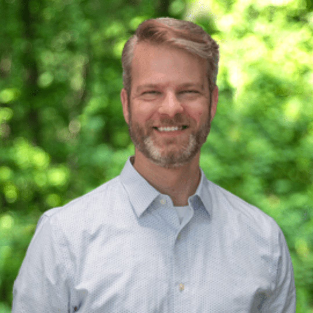 Steven Skerritt-Davis headshot. Man smiling in light, collared shirt.