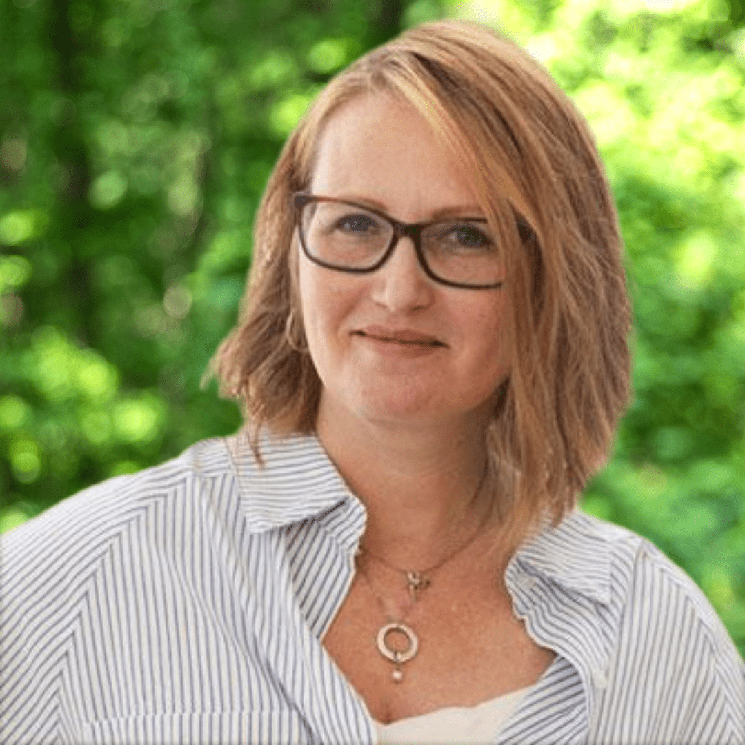 Tammy Oppel headshot. Women smiling with glasses and a light blue collared shirt.